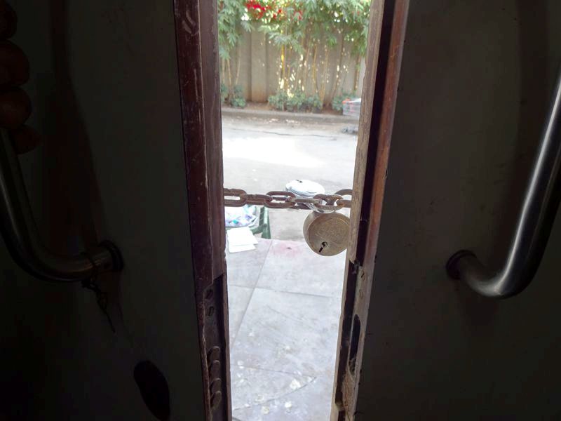A close-up showing the chain-locked door.